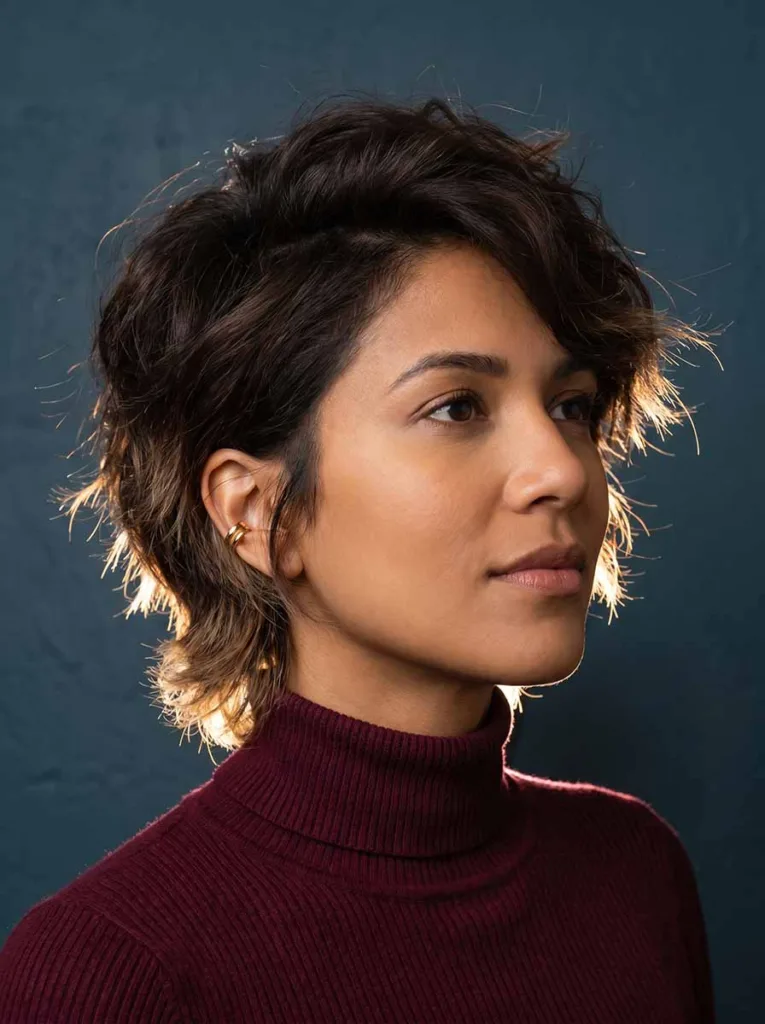 Woman with thick dark hair in a point-cut bixie showing reduced weight and natural movement — bixie for thick hair