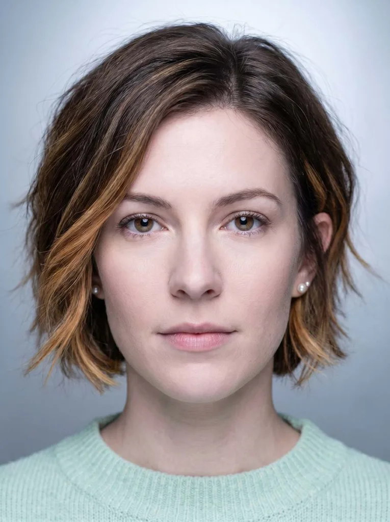 Woman with bixie haircut and face-framing highlights adding brightness around the face — bixie with highlights