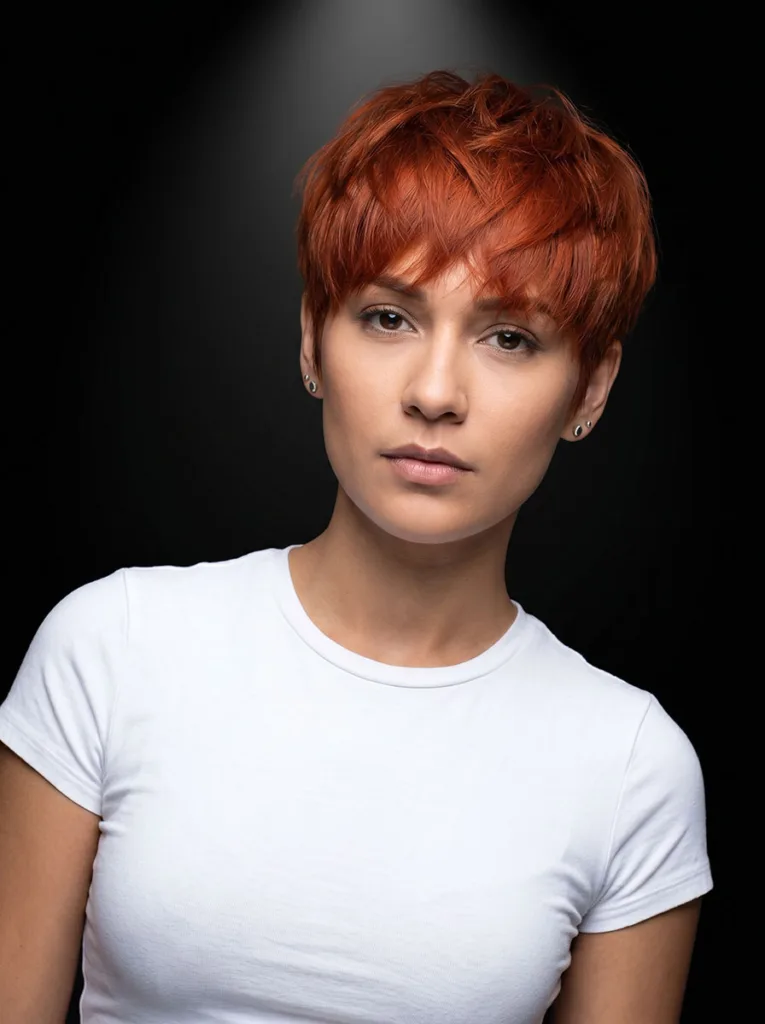 Woman with bixie haircut in vivid copper red bold hair color — bold color bixie hairstyle