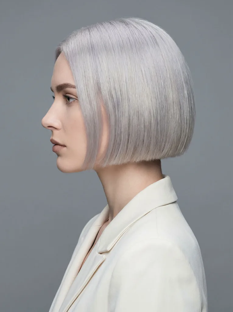 Woman with minimalist clean-lined bixie haircut with no fringe and precise shape — minimalist bixie hairstyle
