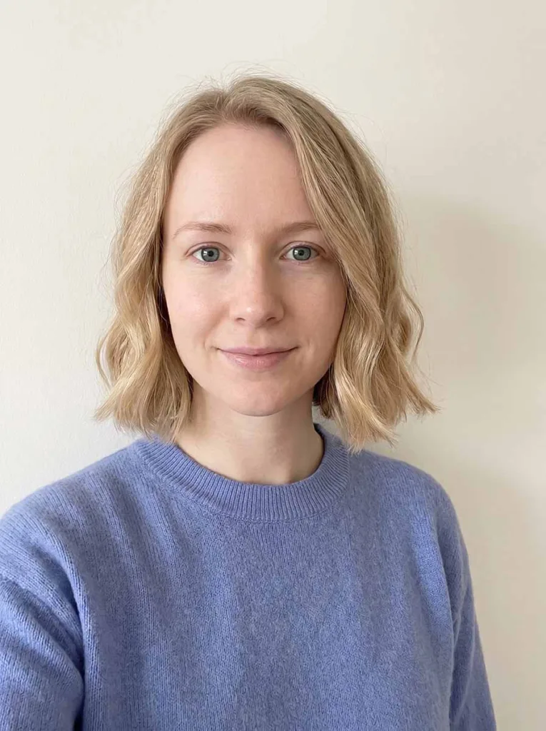 Woman with fine hair wearing a blunt wavy bob, light waves adding volume to thin straight hair