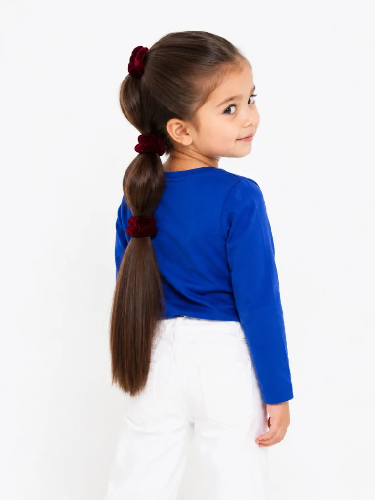 Stacked ponytails toddler hairstyle for long thick dark hair — rear studio portrait