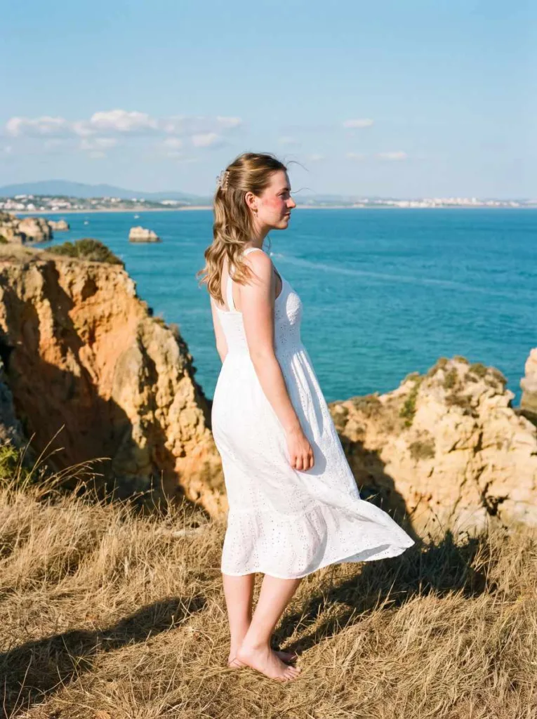 glossy half-up half-down beach glam waves wet look hairstyle on cliff overlooking Mediterranean ocean