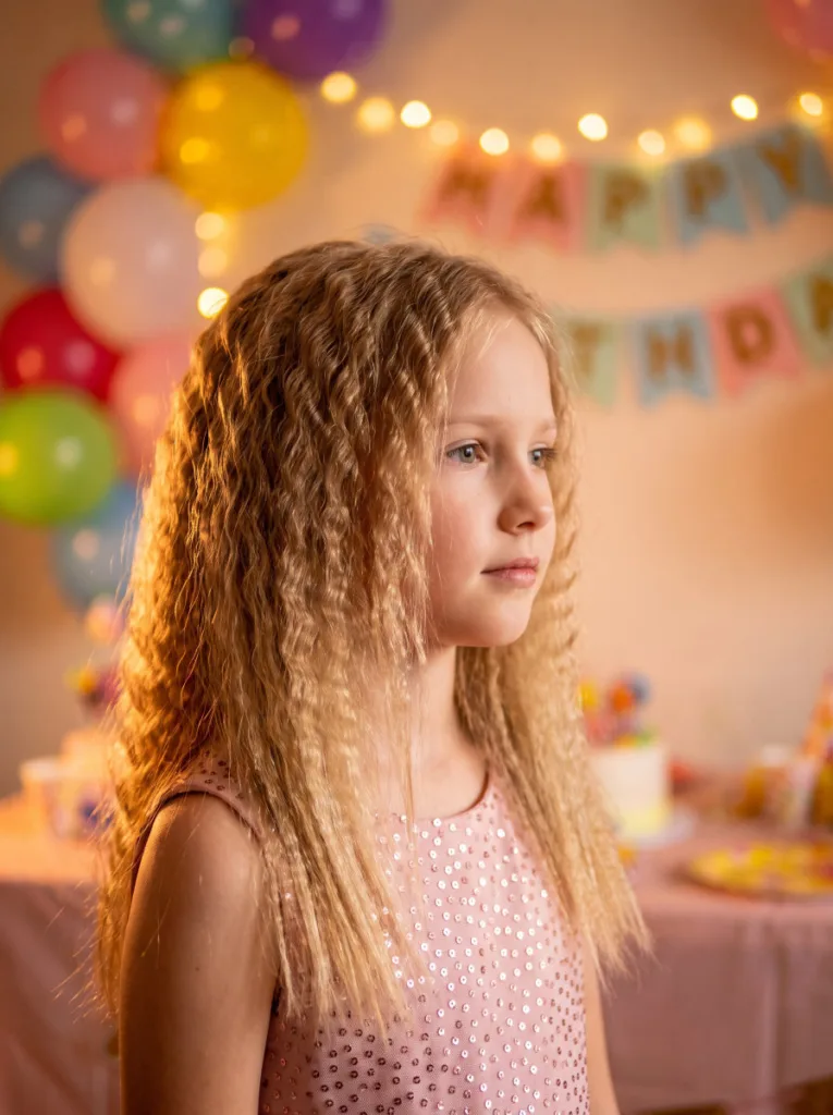Girl with crimped curls hairstyle at a birthday party