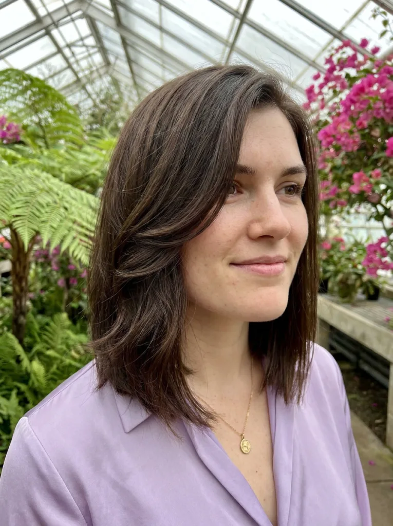 Dark brown layered asymmetrical lob with face-framing layers softening a square jawline