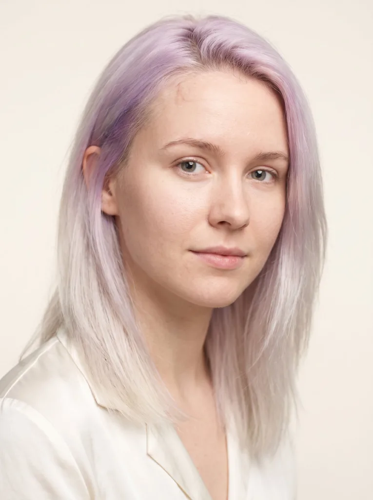 Woman with pastel violet fading into white-blonde hair color