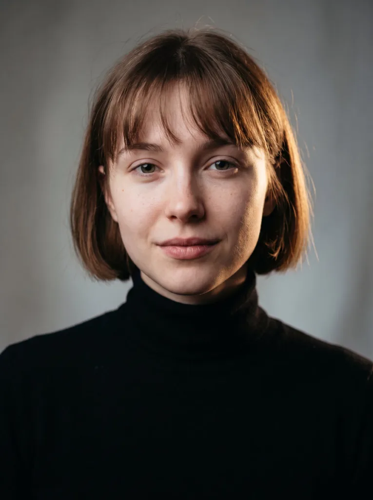 Woman with a French bob and wispy curtain bangs at chin length