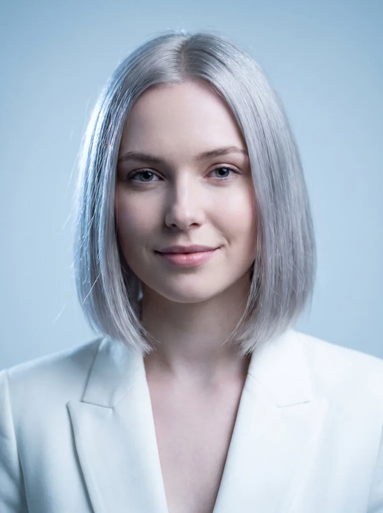 Woman with a chin length bob styled in a fashion silver gray tone