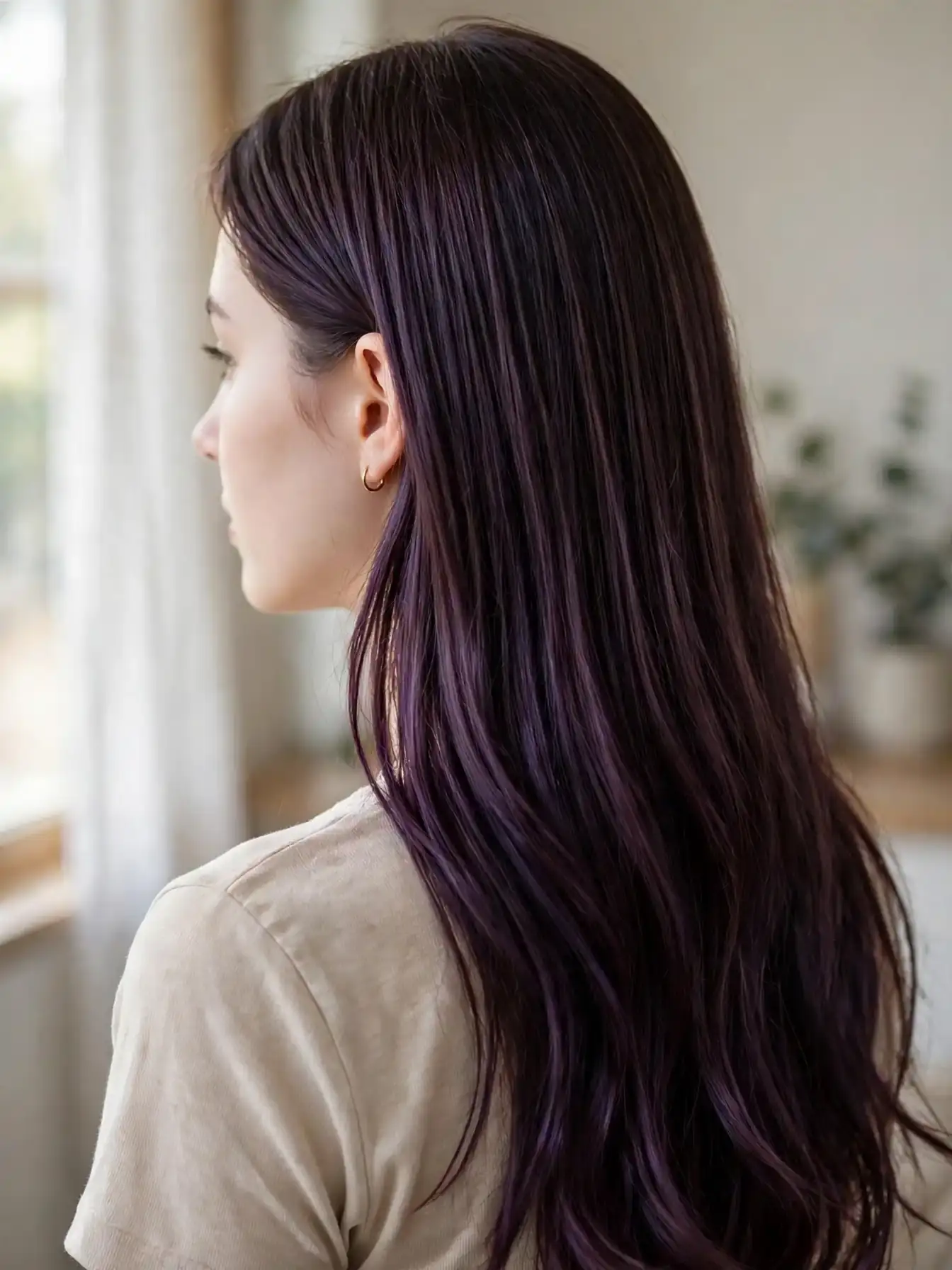 Classic all-over plum brunette hair color with even violet tones from roots to ends