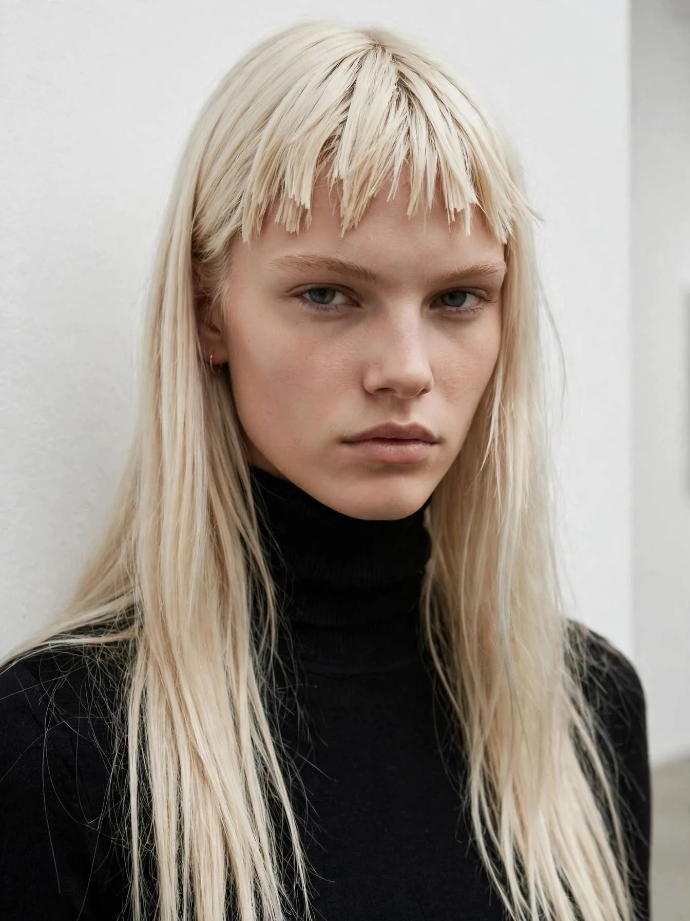 Long straight platinum blonde hair with short choppy piecey baby bangs