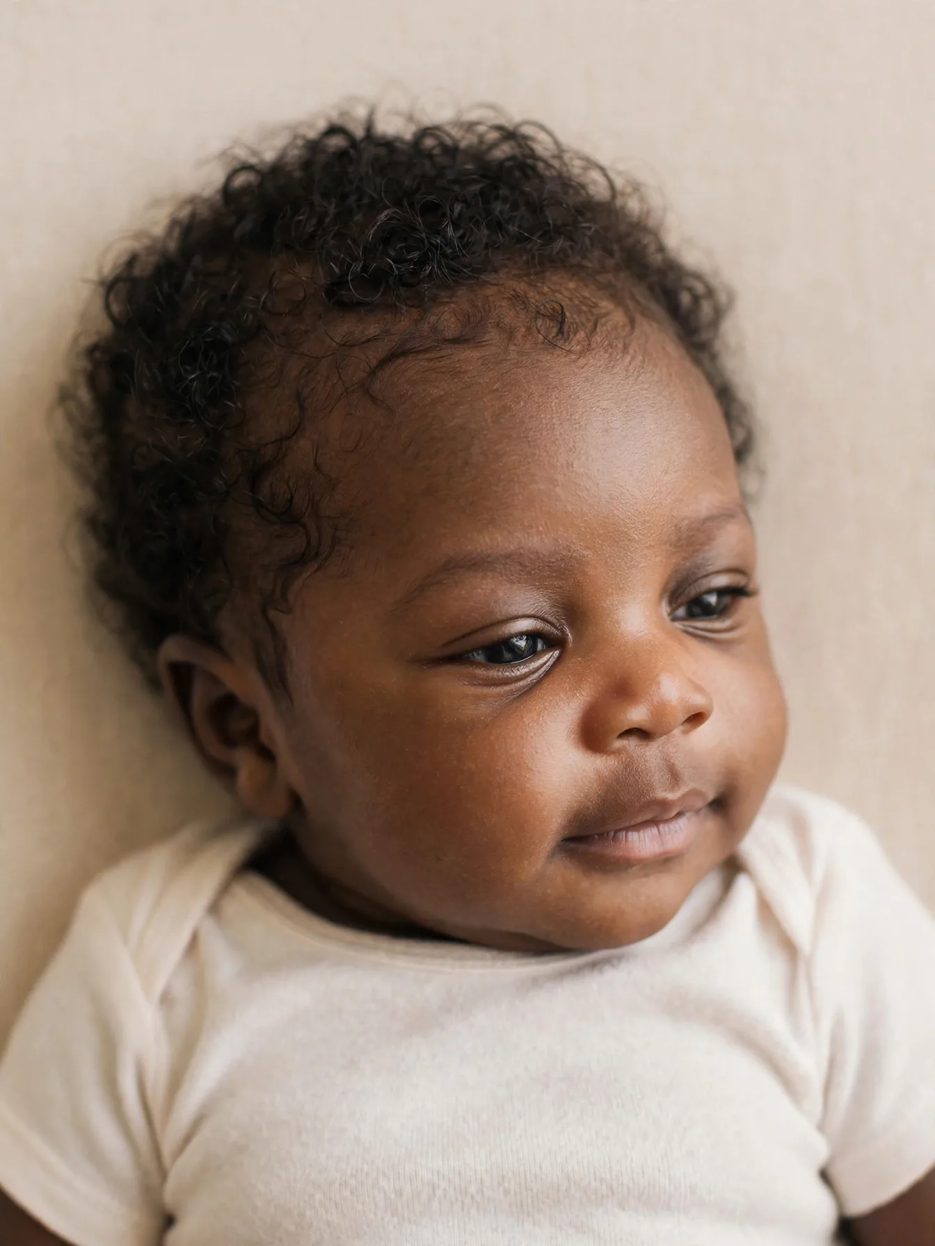 newborn with defined natural curls for photo day