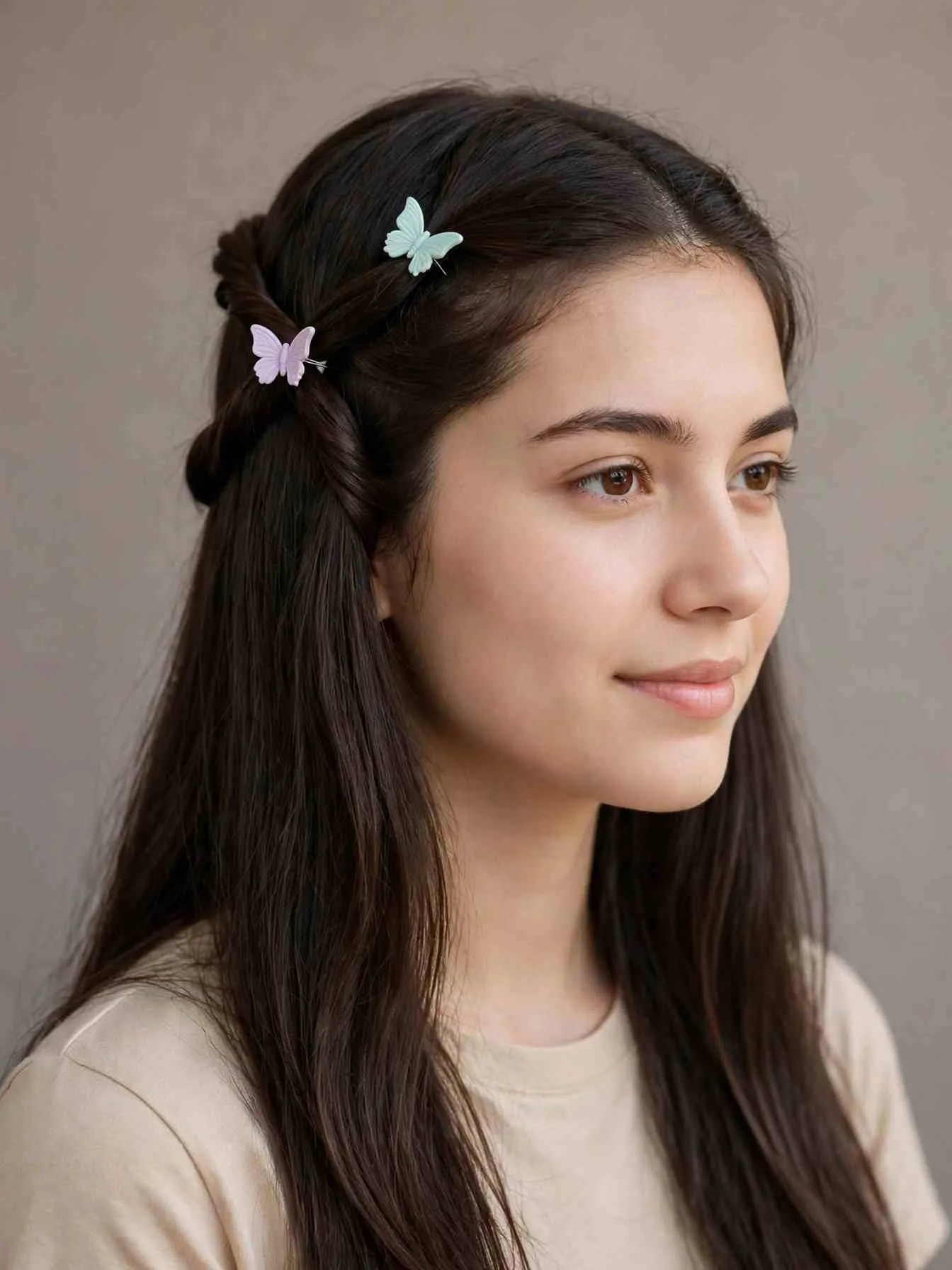Double-twist crown hairstyle with two mini butterfly clips pinning twisted sections