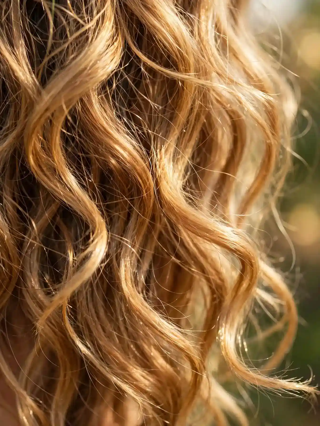 Close-up of loose wild wave texture in sunlit hair