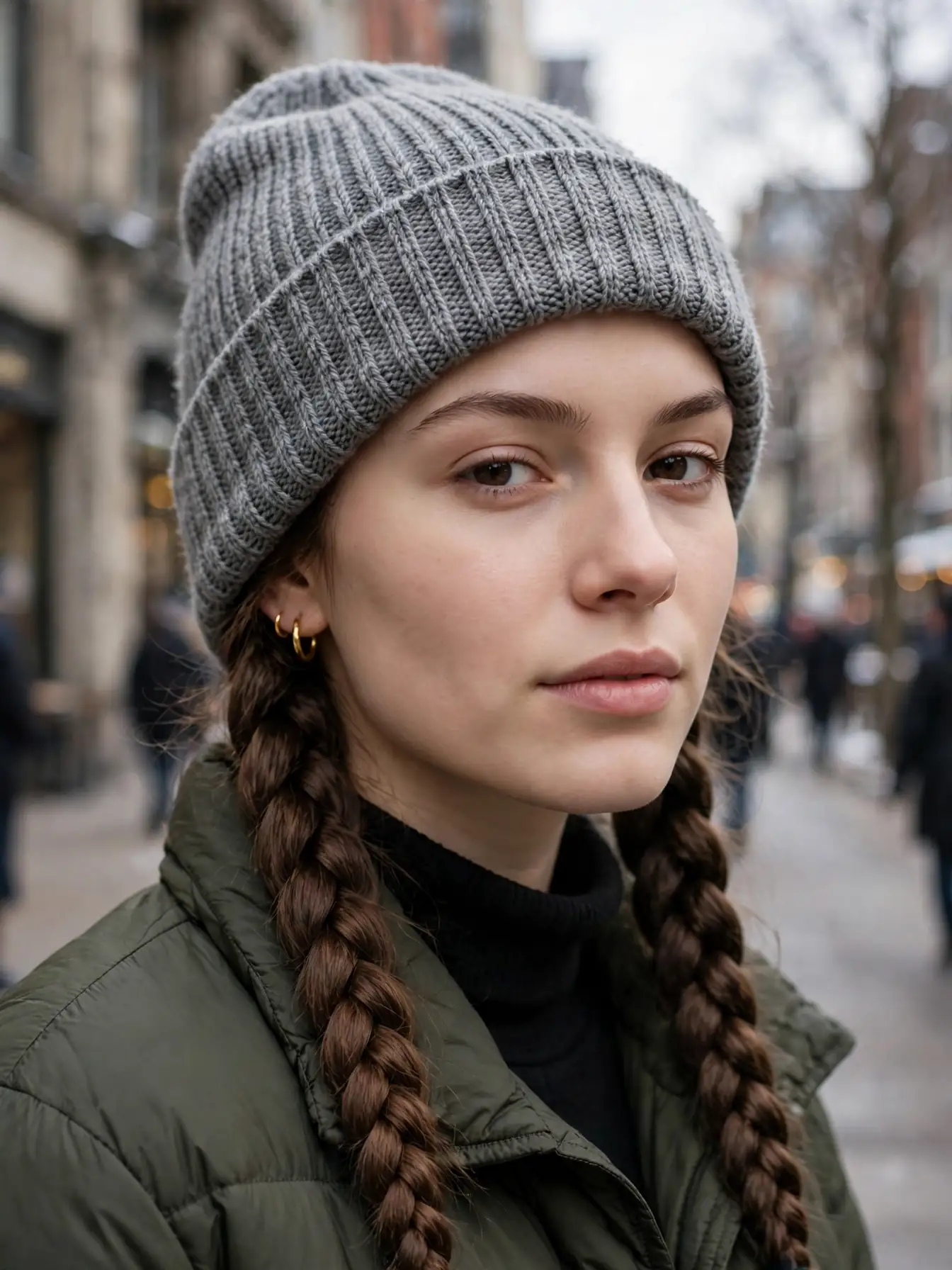 Double Dutch braids worn under a knit beanie